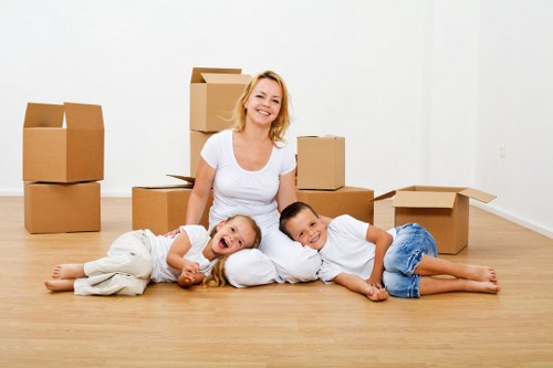 Local moving team handling furniture near Blackwall apartment buildings