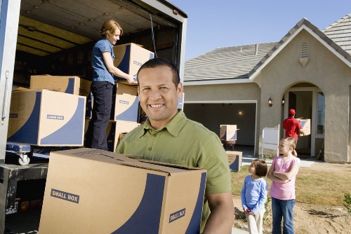 Careful loading of boxes and furniture into a moving van in Blackwall