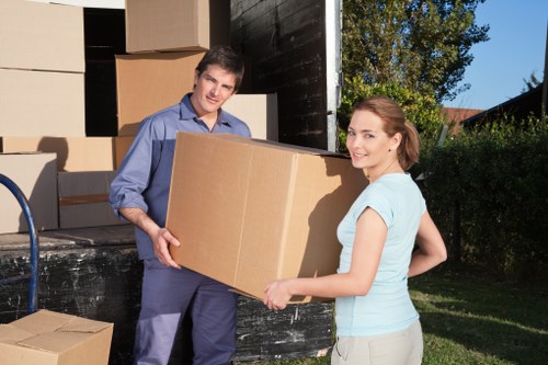 Local removals van loading near Blackwall residential buildings